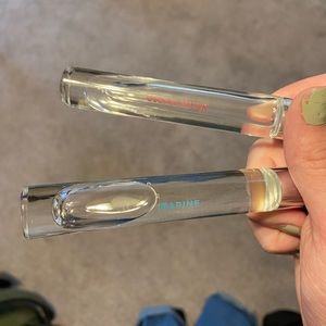 Woman roll on perfume.